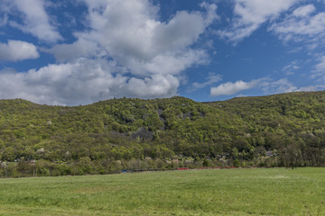 Fototapeta na wymiar Meadows and hills near Kostov village in green valley