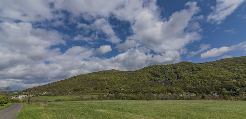 Fototapeta na wymiar Meadows and hills near Kostov village in green valley