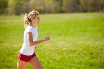 Woman runner runs - workout in spring