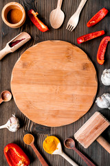 Professional kitchen with spices for cook on wooden background top view