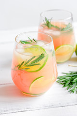 healthy morning with fresh drink, lime and rosemary on white table background