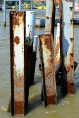 Fototapeta na wymiar Metal posts left over from an old pier in Chao Phraya River Bangkok, Thailand.