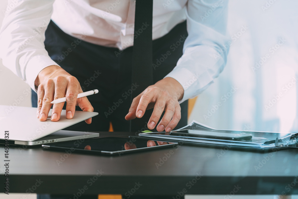 Aufkleber close up of businessman working with smart phone and digital tablet and laptop computer on wooden de