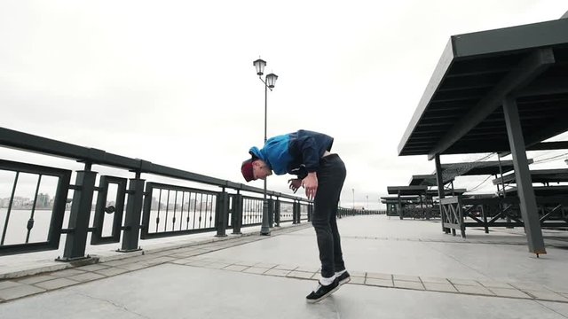 Acrobatic parkour teenager doing backflip - slow motion