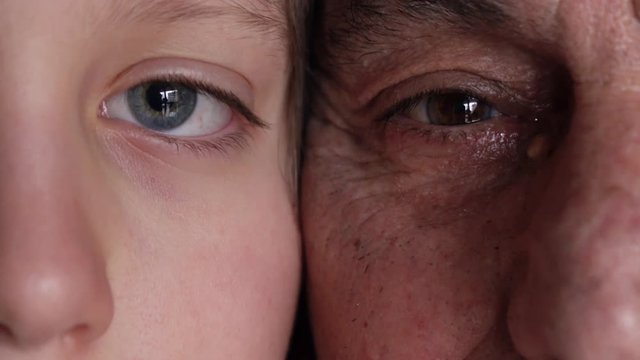 Generations comparing: close up on grandpa and grandson eyes