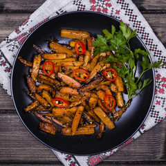 Roasted carrots in black plate, close up