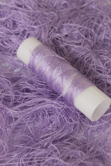 Fototapeta na wymiar Pastel Purple sewing thread roll background