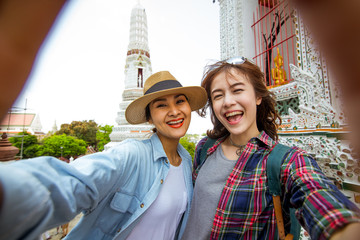 Naklejka premium Girlfriends take a selfie at Wat pho in Thailand