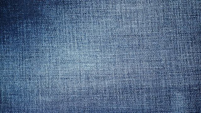 Closeup detail of blue denim jeans, texture background. Dolly sliding shot 4K ProRes HQ codec