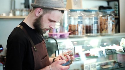 Man with coffee checking phone