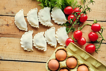 Dumplings with cherry tomatoes, eggs and parsley.