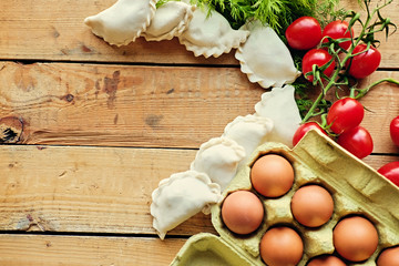 Dumplings with cherry tomatoes, eggs and parsley.