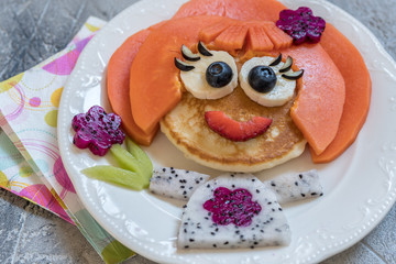 Funny girl pancake face with fruits