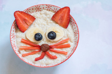 Oatmeal porridge with a kitten face decoration