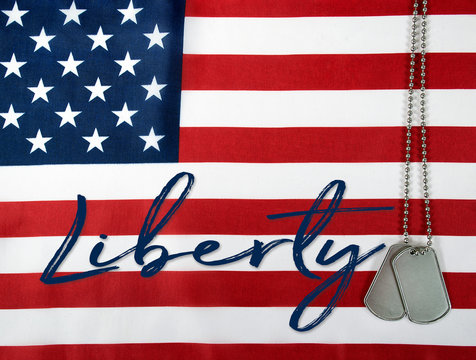 word liberty and military dog tags on American flag background