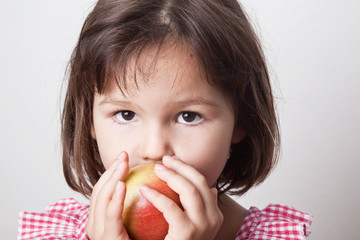 Girl biting an apple 