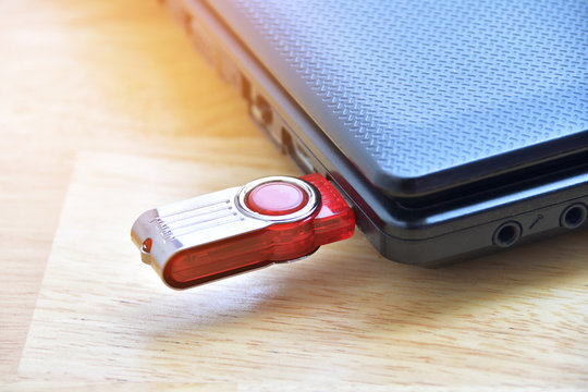 Red Flash Drive In Port Usb With Computer Notebook.