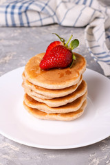 delicious healthy pancakes with strawberries on white plate