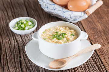 Egg drop soup in white bowl.