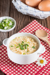 Egg drop soup in white bowl.