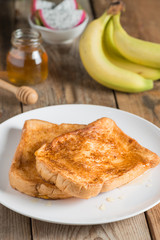 French toast with honey and fruit.