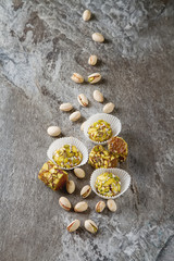 Fototapeta na wymiar Eastern sweets. Turkish delight with pistachios in a vase. Dark gray stone background.