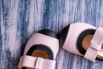 Baby girl pink shoes on colored background. Top view. Copy space.