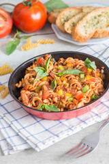 Pasta with tomato sauce in pan.