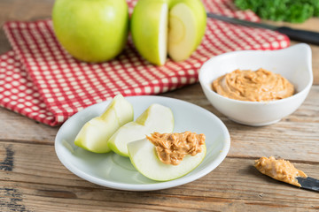 Green apple sliced with peanut butter. © inews77