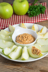 Green apple sliced with peanut butter.