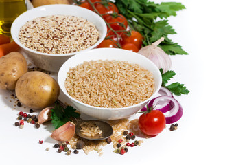 brown rice and quinoa and fresh ingredients for soup on a white background