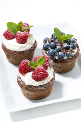 chocolate cupcakes with fresh berries, vertical top view