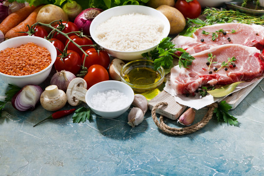 meat and fresh foods for cooking soup on a blue background