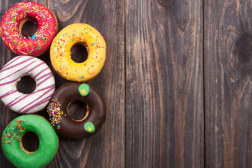glazed donuts on a black wooden background with copy space for your text. Top view