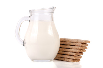 jug of milk with grain crispbreads isolated on white background