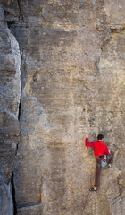 Plakat climber climbs the rock..