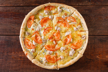 Junk food, bad habits, Pizza sliced on rustic wooden table background, flat lay. Italian cuisine concept.