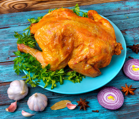 Are fresh the made tasty fried chicken lies on a plate near spices and vegetables