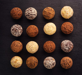 Chocolate truffle,Truffle chocolate candies with cocoa powder.Homemade fresh energy balls with chocolate.Gourmet assorted truffles made by chocolatier.Chunks of chocolate and coffee beans