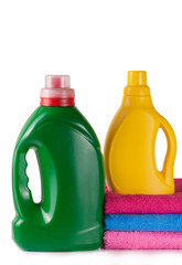 bottle laundry detergent and conditioner with towels isolated on white background