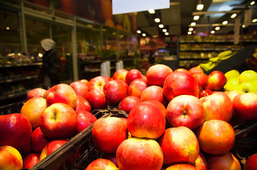 Apples on boxes in supermarket