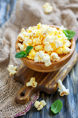 Popcorn with salt in a wooden bowl.