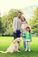 happy family with labrador retriever dog in park