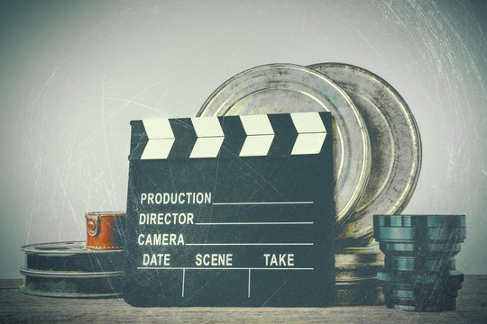 Clapperboard, tin boxes with film and lens