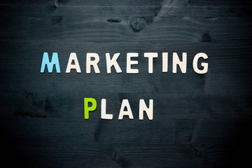 wooden word marketing plan on background business concept