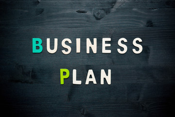 wooden word business plan on background business concept