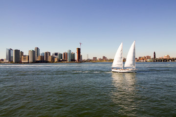 New York skyline with sail boat on water