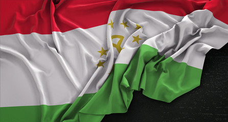 Obraz premium Tajikistan Flag Wrinkled On Dark Background 3D Render