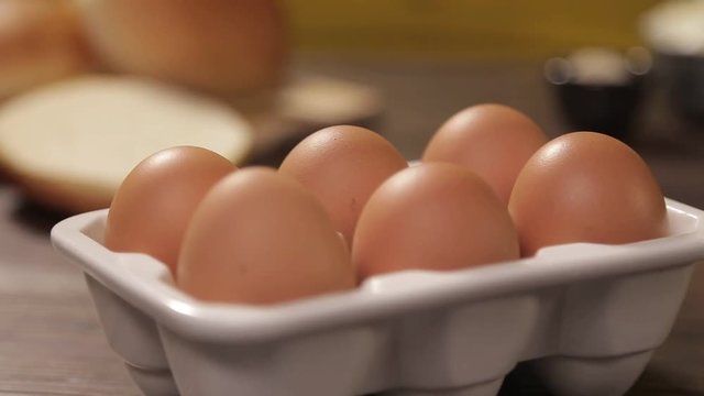 Eggs - 6 Brown Eggs In White Holder On Table - Slider - Right To Left