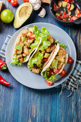 Authentic mexican tacos with chicken and salsa with avocado, tom